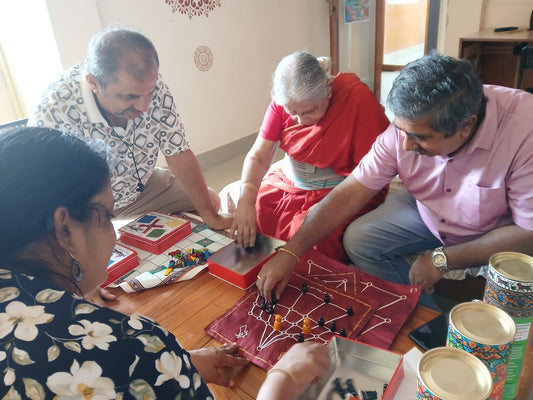A family playing game of aadu huli aata or aadu puli aatam
