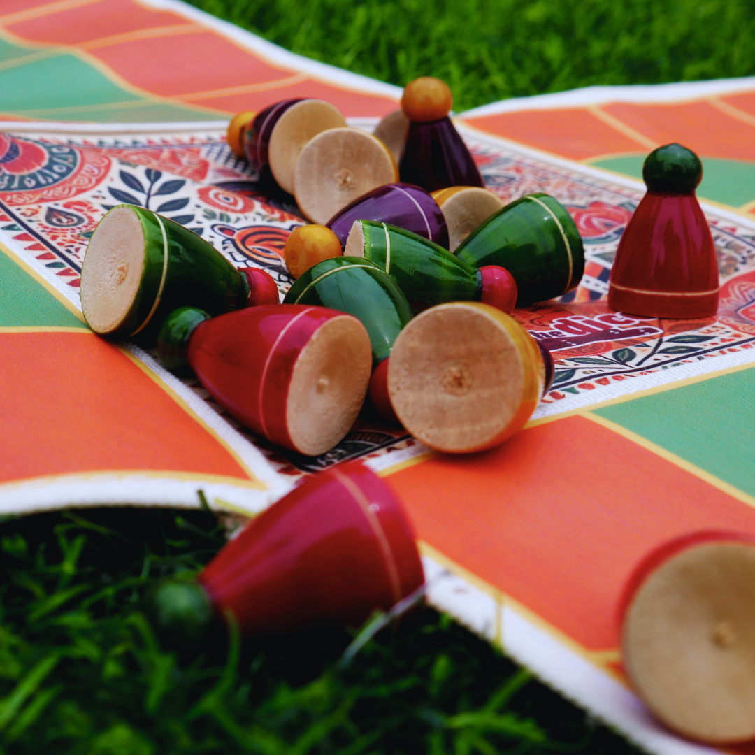 Roll the Dice Pagade classic Indian board game in four colors, featuring traditional Pachisi design and wooden game pieces.