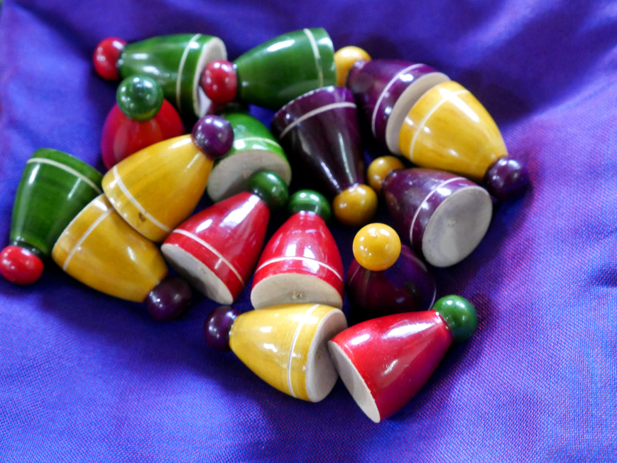 Colorful Pagade Indian board game set with pawns in four vibrant colors for traditional Pachisi play, by Roll the Dice.
