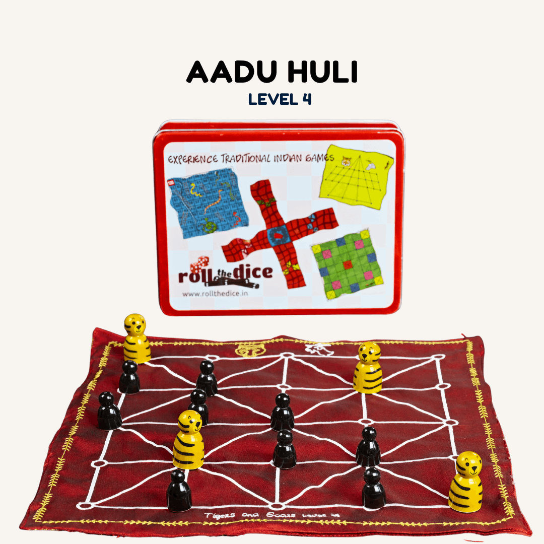 Heritage Aadu Huli board game featuring tiger and goat pieces, played on a traditional wooden game board by Roll the Dice.