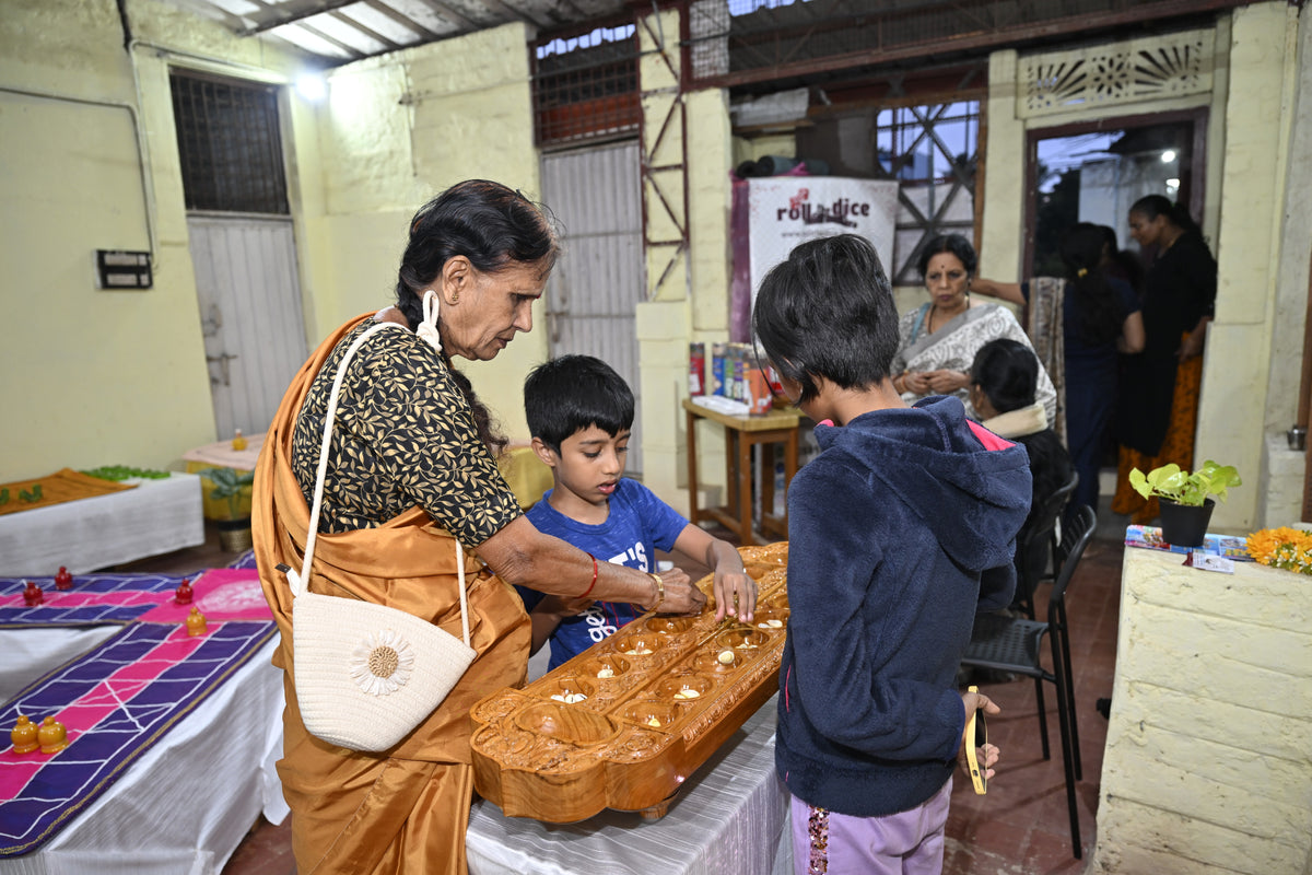 Family members gathered around a traditional wooden board game
