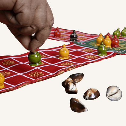 Traditional Indian Pachisi board game by Roll the Dice, showing the colorful Chausar layout on a wooden game board.
