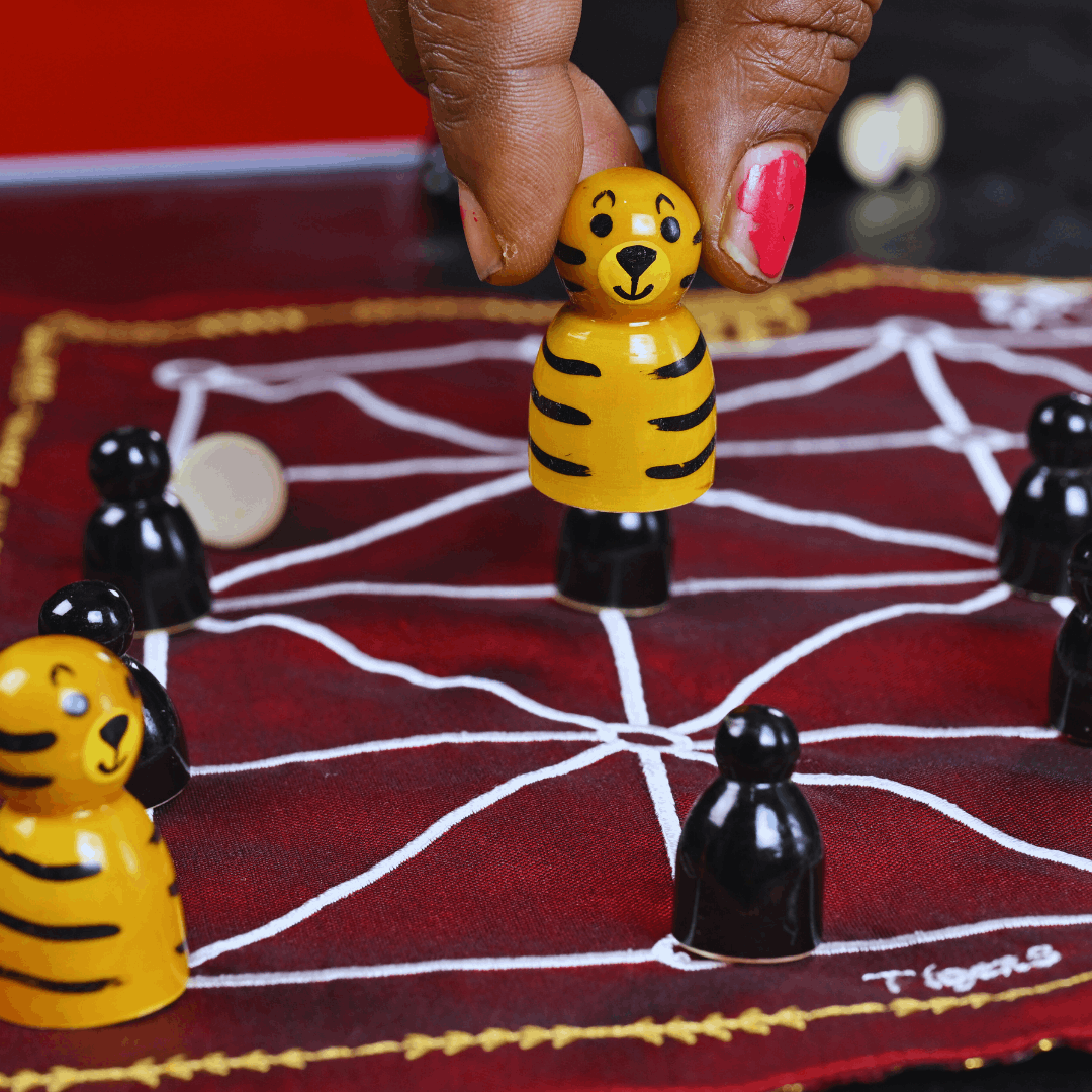 Heritage Aadu Huli board game with tiger and goat pieces, featuring traditional design from Roll the Dice brand.