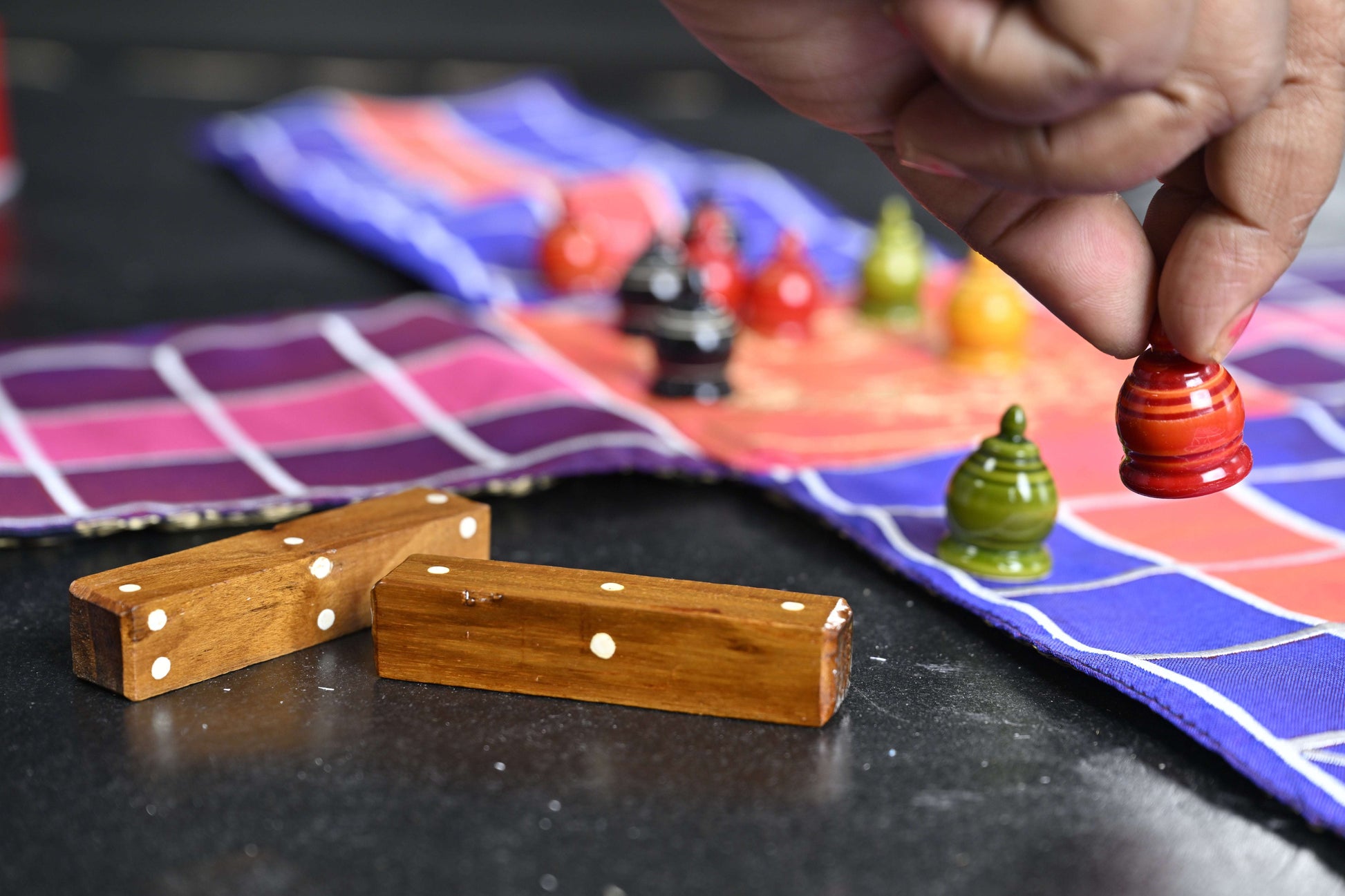 Pachisi board game by Roll the Dice, featuring traditional wooden game pieces on a colorful game board for family fun.