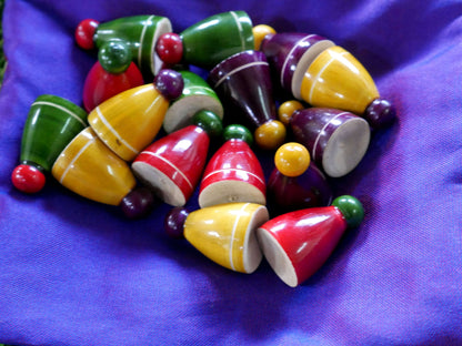 Colorful Pagade Indian board game set with four sets of wooden pawns for traditional Pachisi gameplay, by Roll the Dice.
