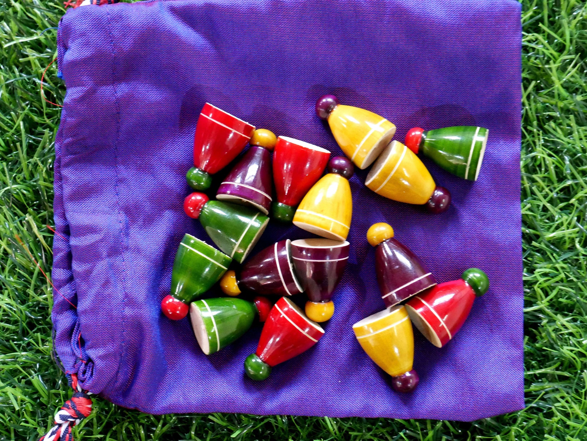 Colorful Pagade Indian board game pawns and game pieces for traditional Pachisi set by Roll the Dice.